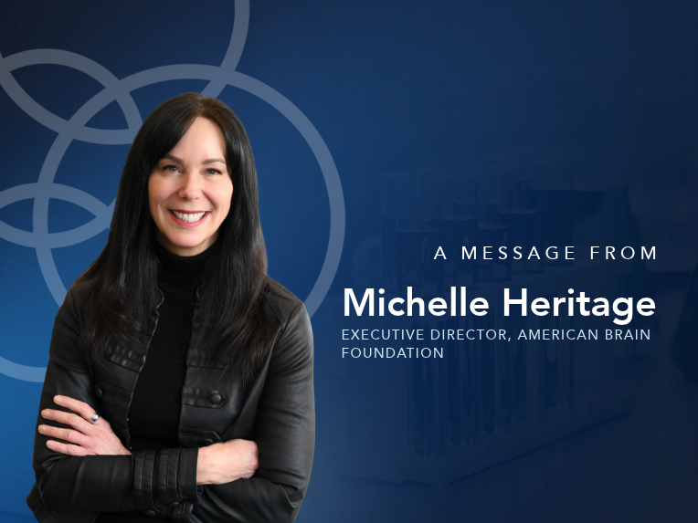 A photograph of Michelle Heritage against a blue background. Text reads "A message from Michelle Heritage, American Brain Foundation Executive Director"